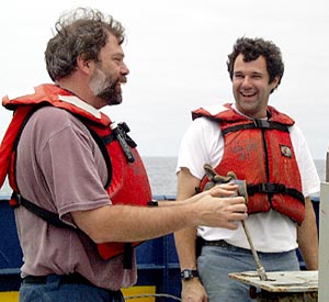 Alberto Saal and Josh Curtice operate the A-frame for the last dredge. 