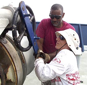 Lorna Allison, Ordinary Seaman, and Butch Harty, Able Seaman, drop the anchor.  