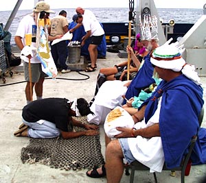 Sparky (Steve Tottori) kneels and confesses his sins before the Royal Court.