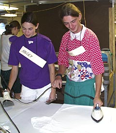 Nosey (Christy Reed) and Catatonic (Ben Grosser) prepare the cruise t-shirts. 