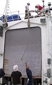 The crew members lower the docking line from the 02 deck to the fan tail in preparation for docking tomorrow.  