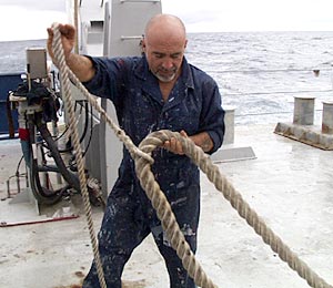  Victor Barnhart, the Bosun, ties down one of the mooring lines on the fan tail. 