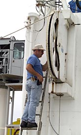 Alden Luallin, Marine Electrician, secures the trawl wire. 