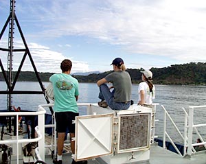 Todd Ericksen (left), Jenny Engels, and Christy Reed watch as Puerto Caldera approches. 