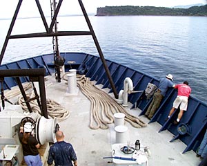  First Mate Erick Wakeman (left) and looks over the side to make sure the anchor is set. 