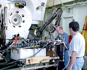  Co-Chief Scientists Tim Shank, left, and Steve Hammond, check equipment in Alvin’s basket before diving today in search of Rose Garden.