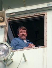 Chief Engineer Kevin Fisk watches from the A-frame control room as the Alvin was recovered in the late afternoon.