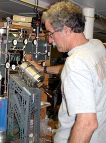  Nighttime is the right time for John Lupton. When Alvin surfaces in the evening, John begins to analyze the fluid samples the sub has collected. Here John extracts gases from the fluids and seals them in ampoules for later analysis in the lab.