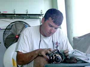  While Alvin was at the bottom, Ordinary Seaman Mike Doherty polishes the brass fire nozzles.