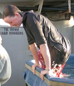  After Rhian’s traditional ice-water dousing, scientists and Alvin Pilots throw her into the pool in recognition of her first dive. 