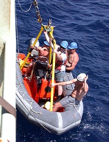 Ed “Catfish” Popowitz attaches an loop to the crane to lift the Zodiac back on to Atlantis after Alvin was launched this morning.