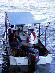  Craig McLean and Victor Rodriguez leave Atlantis this morning in a “panga” — the name given in the Galápagos Islands to small boats.