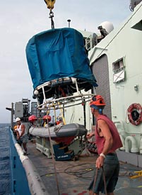 Ordinary Seamen Raul Martinez and Kevin Threadgold help guide the Conductivity, Temperature, and Depth sensor, or CTD, to the ship’s deck. This device was dropped into the water from there, with the winch that had only been repaired two days ago. The crew brought the CTD back up later in the day.