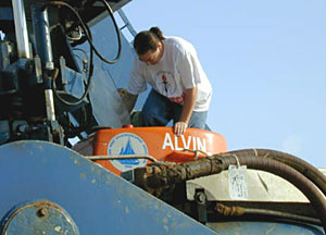 Chief Scientist Jess Adkins climbing into the titanium sphere of Alvin, just minutes before launch.