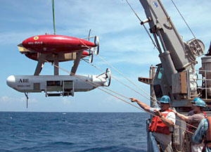 Normally, ABE, the autonomous benthic explorer, dives in the evening, after Alvin has come back on board. But Alvin's postponement allowed ABE to have the day. Here crew members help guide ABE into the ocean.  