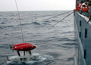 ABE is steadied by Bosun Wayne Bailey, Able Seaman Kevin Threadgold, and Ordinary Seaman Raul Martinez as it is hoisted on board.  