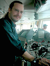 2nd Mate P.J. Leonard, during his watch on the bridge. This photo was taken late Monday morning, shortly after the day's Alvin dive had been cancelled. High winds and swells postponed our return to the ocean floor yet another day.  