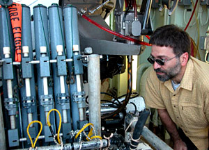 Alvin doesn't just bring up corals. Here Chemist Diego Fernandez checks out the water samples collected from different places or 'stations" during today's dive. 