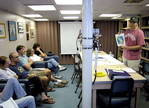 Scientists Laura Robinson and Alex Gagnon hard at work "scripting," or programming, a suite of options for which path the ship should take for future SeaBeam operations. The choice of which path to take will depend on whether the weather continues to deteriorate.