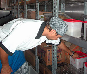Ship’s cook Al DaLomba looks through the walk-in refrigerator while planning an upcoming meal. On a multi-week cruise, it's important to have a good sense of what ingredients need to be used in what order. If you let something spoil, you can't run out to the store to replace it.