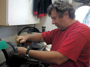 Expedition Leader Pat Hickey at work on a lathe in the ship's machine shop. There is an ample supply of spare parts for all sorts of machinery on board, but you can't plan for everything: At some point you have to make some things that are needed.