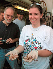 Biologist Kate Buckman holds two crematulids, otherwise known as stalkless crinoids, after mining the collection basket from today's Alvin dive. Fellow biologist Jon Moore looks on, with sub pilot Bruce Strickrott in the background.