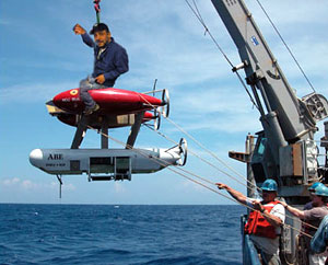 ABE guru Dana Yoerger rides his robot, in the first manned ABE launch in history. No, that's a joke. Actually, this is a photograph of ABE being launched several days ago, doctored to look like Dana's aboard. While no one actually climbs on ABE, the group of engineers, scientists and technicians who work with it pour all their knowledge and experience into every ABE dive.