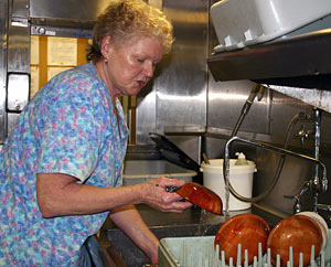  Mess Attendant Linda Bartholmee makes the galley sparkle. Each day she washes more than 800 plates, bowls, spoons, forks, and knives—not counting pots and pans. 