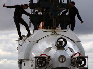 Thumbs up by swimmers Mark Spear (left) and Raul Martinez indicate that a hook lifting the 16-ton (17.6-metric ton) Alvin is clear. 