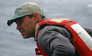 Pelting rain and wind during recovery of three transponders from the seafloor caused Seaman Jack Greenberg to squint as he searched the water surface for the ascending ocean instruments. 
