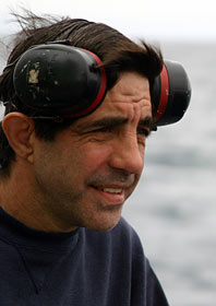 Protective earmuffs are standard issue for working in the engine room of Atlantis. Oiler Mike Spruill has been working on Woods Hole Oceanographic Institution research vessels since February 2002. He’s often in the noisy engine room assisting engineers. “I wear them all the time,” he said of the earmuffs. “So sometimes I just forget they are up there.”