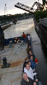 Gliding through the locks in Ballard, Washington, scientists gather at the ship’s rails and on the bow for their return to the city. 
