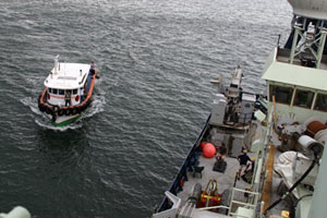 In Puntarenas we anchor offshore to prevent damage to the ship from waves that may push the vessel against the dock. Small boats ferry passengers and gear to the vessel throughout the day. (Photo by Amy Nevala)
