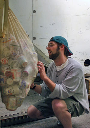 Chemist Nick Pester examines dozens of cups ready to join Alvin on the seafloor during this expedition’s first dive.