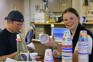 Chemist Nick Pester examines dozens of cups ready to join Alvin on the seafloor during this expedition’s first dive.