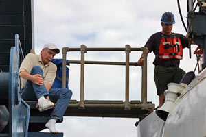 Chemist Bill Seyfried, making the fifth Alvin dive of his career, knows that shoes aren�t allowed in the submersible. Removing shoes keeps the sub clean and protects instruments inside from an accidental kick.