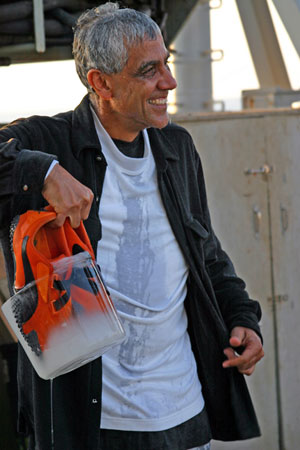 WHOI guest Vinod Khosla made his first Alvin dive today, with biologist Tim Shank and pilot Bruce Strickrott. Following the dive, he was initiated with buckets of water. And though pranksters also froze his shoes, he said the dive �made it to the list of top ten things I�ve done in my life.� (Photo by Amy Nevala)