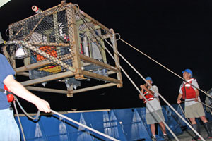 Scientists and ship�s crew deploy TowCam, used to photograph the seafloor and collect shards of glassy lava. (Photo by Amy Nevala)