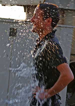 WHOI guest Peter Nomikos receives a traditional cold water dousing following his first Alvin dive today.