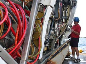 Minutes after Alvin was brought on to Atlantis following the last dive on this expedition, expedition leader Pat Hickey and other pilots began removing panels, called �skins,� for cleaning. (Photo by Amy Nevala)