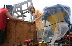 Seaman Robert Barrett and biologist Stace Beaulieu pack biology equipment on deck to prepare for leaving the ship when we reach Costa Rica on Friday morning. (Photo by Amy Nevala)