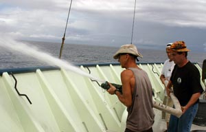 5. During a fire drill today, Atlantis crew Kevin Threadgold (left), Stuart Meacham, and Rob Barrett practiced maneuvering a fire hose. (Photo by Amy Nevala)
