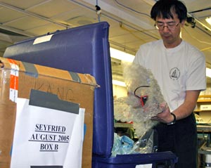 6. Chemist Kang Dang packs research equipment in labeled boxes that will be stored on the ship until his return with chemist Bill Seyfried in August. The scientists expect to continue their research at the Juan de Fuca Ridge, off the Pacific Northwest coast. (Photo by Amy Nevala)