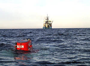 Alvin is diving. All that can be seen is the top of the red sail. 