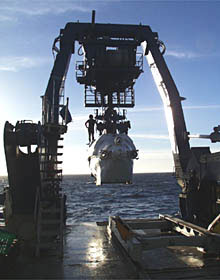 The A-frame swings Alvin over the stern of the ship. 