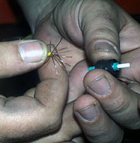 The tip of each glass strand is inserted through a special connector, glued and polished. By placing the polished tips together light can pass from one glass strand to the other. The copper wires on each cable are crimped to make a mechanical connection. 